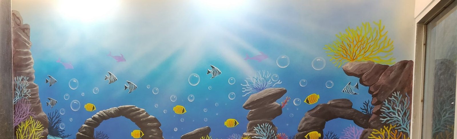 The hand-painted ocean mural in the children's waiting area at Anuj Children Hospital, Vadodara